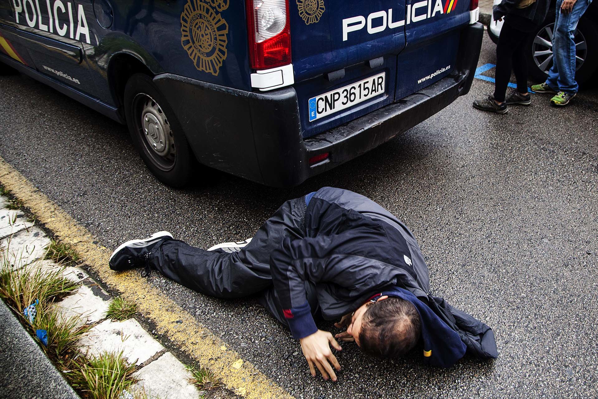 A citizen is injured by members of the Spanish National Police during an operation to requisition ballot boxes at a polling station in Barcelona.