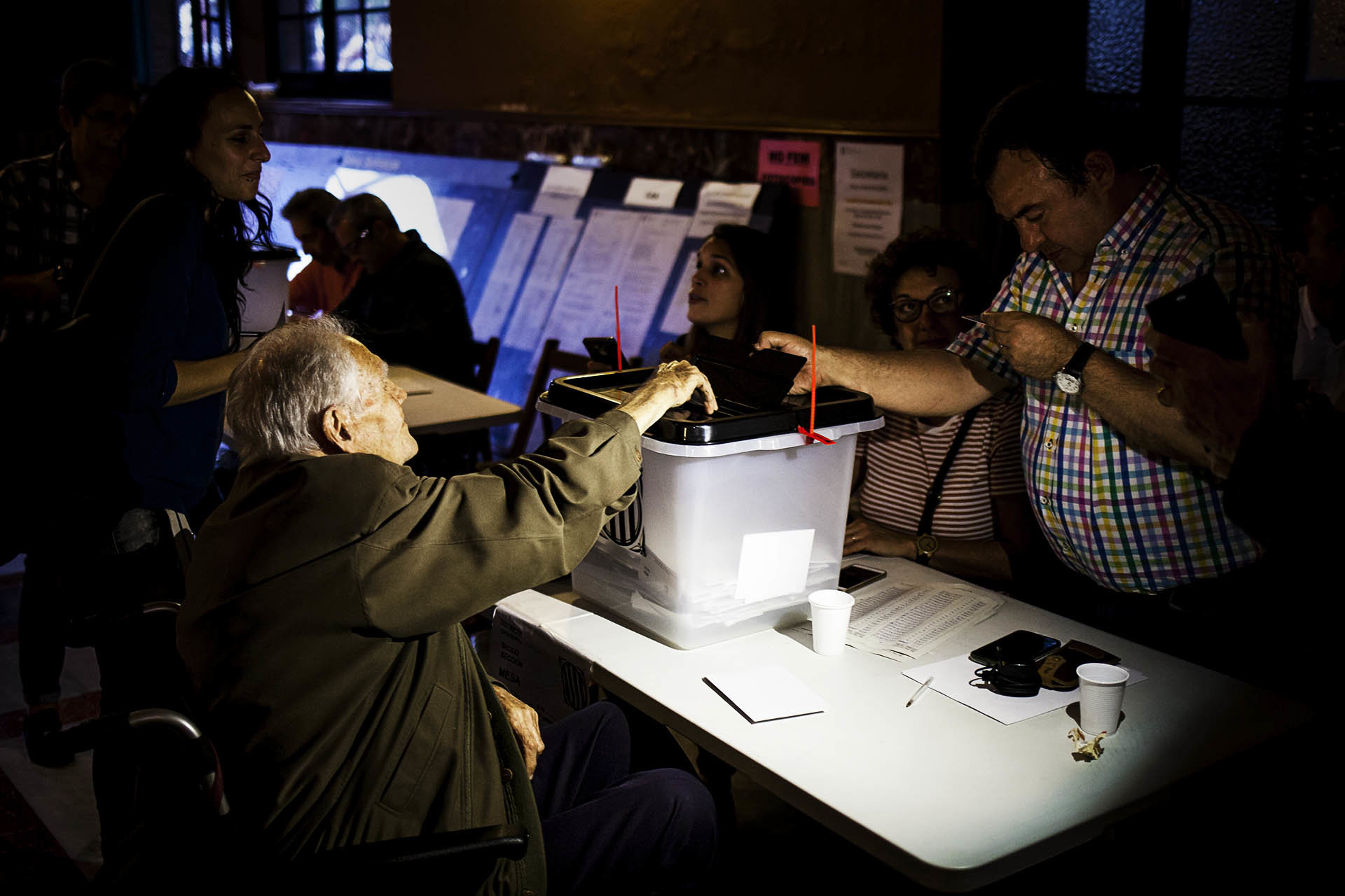 An elder exercises his right to vote in an electoral college in Barcelona
